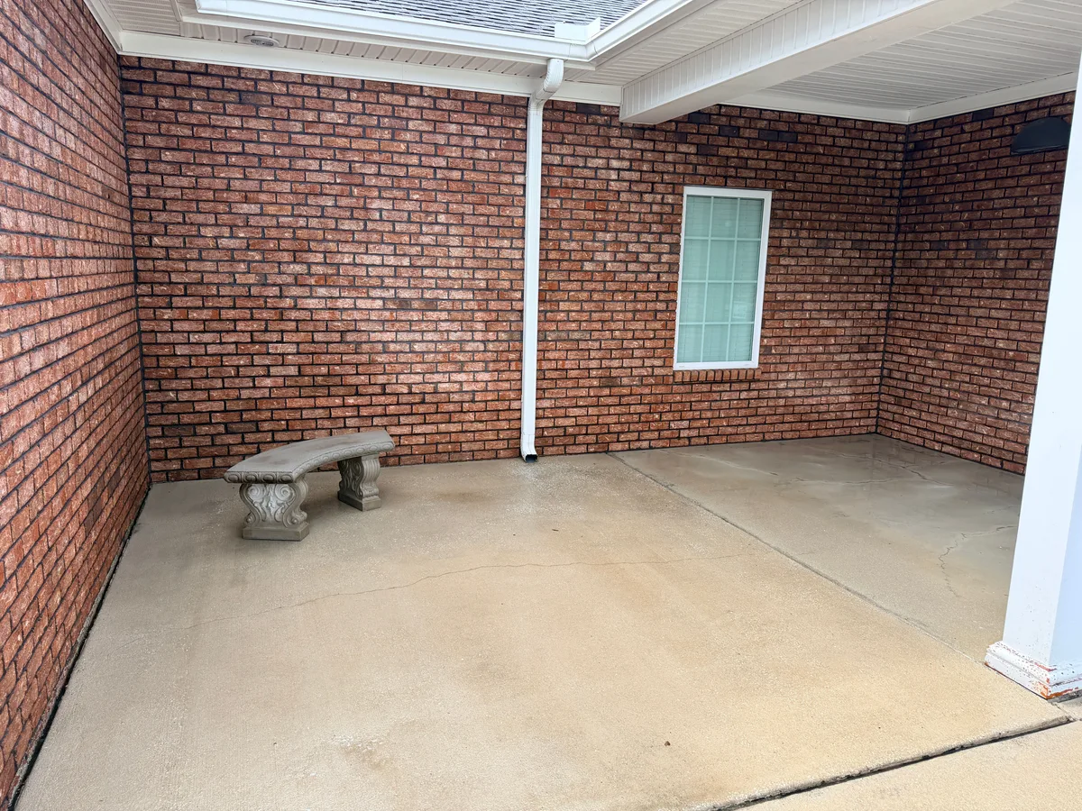 Clean even concrete in the same brick entry courtyard after pressure washing