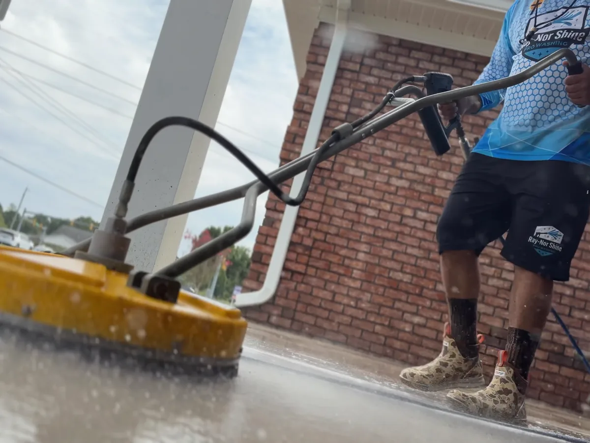 Ray-Nor-Shine running a rotary surface cleaner across concrete in Jacksonville NC